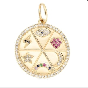 May include: A circular gold pendant featuring a border of small white diamonds. The centre is divided into six segments containing an eye, a lightning bolt, a heart, a star, a crescent moon, and a rainbow, all accented with various coloured gemstones.