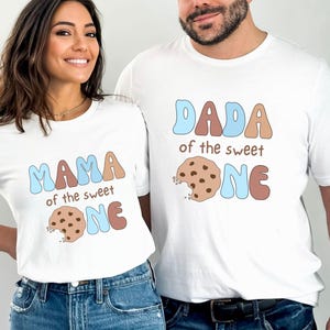 May include: Two white t-shirts with a cookie graphic and the text "Mama of the sweet one" and "Dada of the sweet one".
