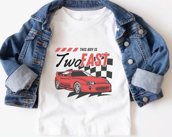May include: White t-shirt with a red race car and the text "This boy is Two FAST" in red letters.