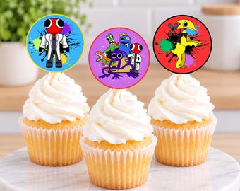 May include: Three cupcakes topped with circular paper toppers featuring cartoon characters. The left topper shows a red-headed figure in a white coat on a blue background. The centre shows a group of colourful creatures on purple. The right shows a yellow bird-like creature on red.