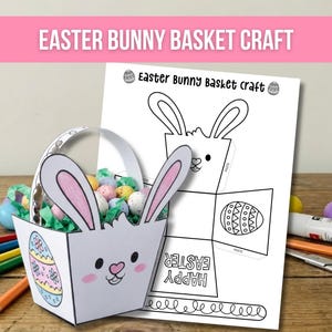 Peut inclure: Un panier de Pâques en forme de lapin blanc avec des oreilles doublées de rose, rempli d'œufs tachetés colorés et d'herbe en papier vert. Le panier a un visage de lapin et un motif d'œuf de Pâques. Un modèle imprimé avec des instructions est à côté.
