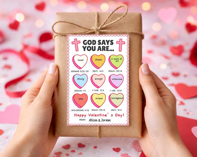 May include: A wrapped gift with a decorative tag that reads "God Says You Are..." with various positive affirmations in heart shapes. The tag also includes the text "Happy Valentine's Day!" and the names "Allison & Jordan".