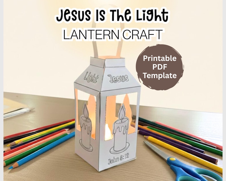 May include: A white paper lantern craft with the text "Jesus Is The Light" and "Lantern Craft". The lantern has candle illustrations and the text "Light" and "Jesus". A "Printable PDF Template" graphic is also present. Colored pencils and scissors are in the background.