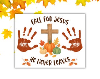 May include: A white rectangular print with the text "FALL FOR JESUS He NEVER LEAVES". The print features a wooden cross, three pumpkins, and two handprints. Autumn leaves are scattered around the text and pumpkins.