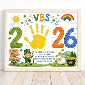 May include: A framed print featuring the text VBS 2026 with a yellow handprint in the center. It includes a leprechaun, a sheep, a pot of gold, a rainbow, and the text of Psalm 23. The design is colorful with green, orange, and blue accents.