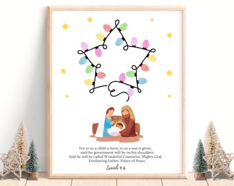 May include: A framed print with a star-shaped string of Christmas lights in pastel colours. The image depicts the Nativity scene with Mary, Joseph, and baby Jesus. The text "For to us a child is born...Isaiah 9:6" is printed below the image.