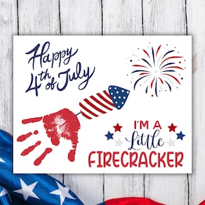 May include: A white card with red, white and blue handprint art. The card says "Happy 4th of July" and "I'm a Little Firecracker".