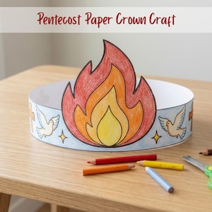 May include: A paper crown craft with a flame design in red, orange, and yellow. The crown has a white base with illustrations of doves, crosses, and stars. The text "Pentecost Paper Crown Craft" is at the top. Coloured pencils and scissors are nearby.