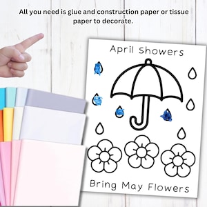 Puede incluir: Un proyecto de manualidades con una ilustraci&oacute;n en blanco y negro de un paraguas, flores y gotas de lluvia, con el texto "April Showers Bring May Flowers". Una mano se&ntilde;ala una pila de papel de construcci&oacute;n de colores.