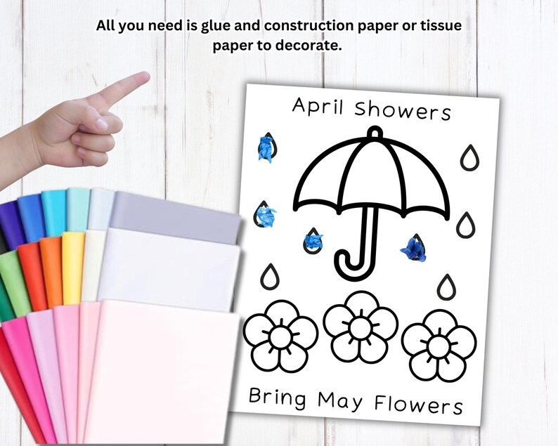 Puede incluir: Un proyecto de manualidades con una ilustraci&oacute;n en blanco y negro de un paraguas, flores y gotas de lluvia, con el texto "April Showers Bring May Flowers". Una mano se&ntilde;ala una pila de papel de construcci&oacute;n de colores.