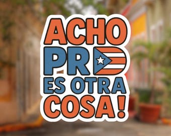 May include: A sticker with the text "ACHO PR ES OTRA COSA!" in orange and blue, with the Puerto Rican flag incorporated into the design. The sticker has a white border and is set against a blurred outdoor background.