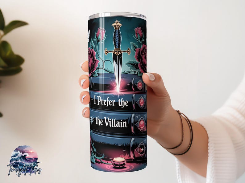 May include: A stainless steel tumbler featuring a design with a dagger, roses, and the text "I Prefer the Villain." The design is set against a dark teal background with a candle at the bottom. The tumbler is held by a person.
