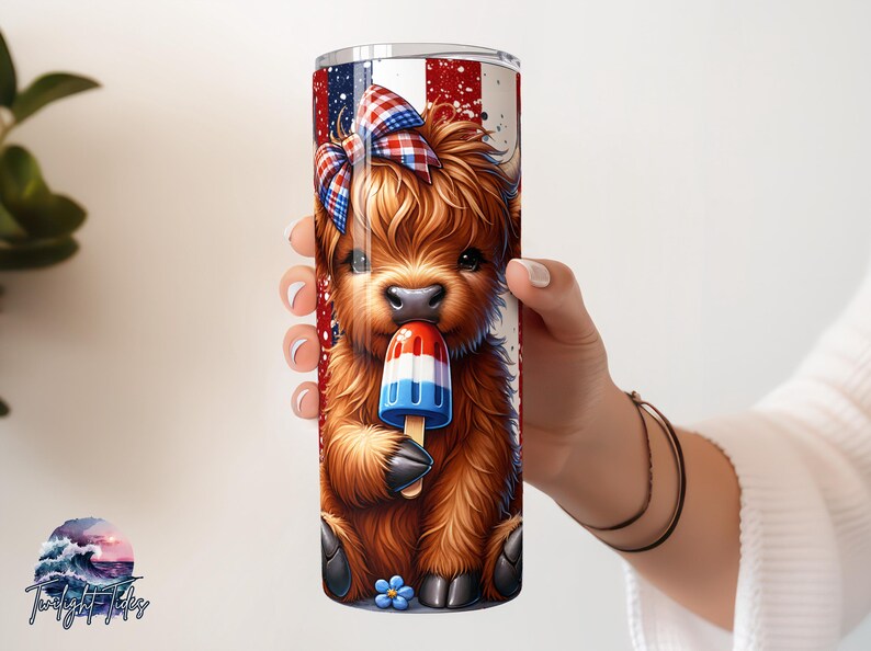 May include: A tumbler featuring a cartoon Highland cow with a red, white, and blue bow and a popsicle. The tumbler has a patriotic design with red and white stripes and blue accents. The cow is brown and fluffy.