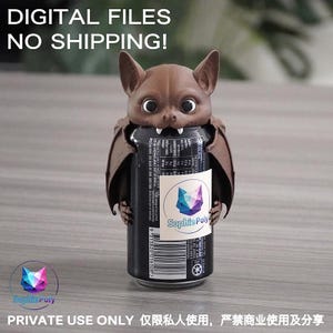 May include: A brown bat-shaped beverage can holder featuring large eyes and two white fangs. The bat is wrapped around a black soda can with a white label displaying the text Sophie Poly and a geometric cat logo. The image includes text stating DIGITAL FILES NO SHIPPING and PRIVATE USE ONLY.