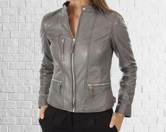 May include: A gray leather jacket with a zip-up front, multiple zippered pockets, and a stand-up collar. The jacket has a fitted silhouette and is made of a smooth, supple material. The jacket is a stylish outerwear option.