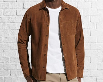 May include: A brown suede shirt with a button-down front and a chest pocket. The shirt has long sleeves and a relaxed fit.