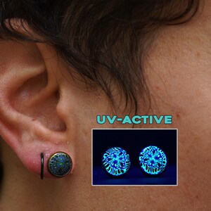 May include: An ear with a black and gold ear plug is shown in close-up. A smaller image displays two glowing blue UV-active ear plugs. The text "UV-ACTIVE" is in a teal box.