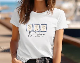 Camiseta "Sé fuerte, sé tú mismo" PNG, diseño motivacional con estampado floral, camiseta con cita de amor propio.