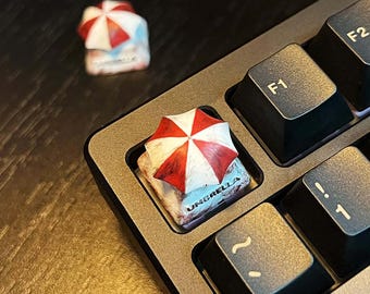 Teclas mecânicas personalizadas 1U para Resident Evil com o logotipo da Umbrella Corporation. Alta qualidade, feitas à mão, colecionáveis, exclusivas, para presentear ou como brinquedo.