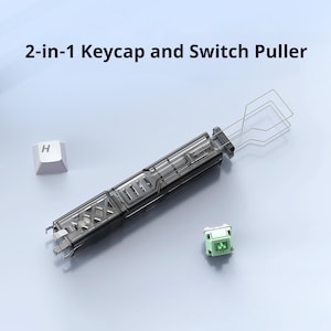 May include: A 2-in-1 keycap and switch puller tool. The tool is dark gray and clear, with a wire keycap puller and a switch puller. A white keycap with the letter "H" is next to the tool, along with a green switch.