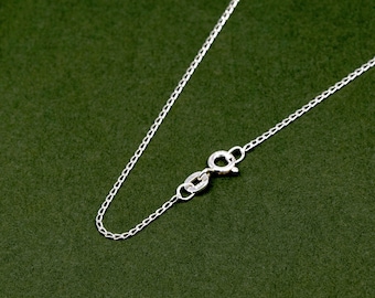 May include: A silver chain necklace with a lobster clasp closure.