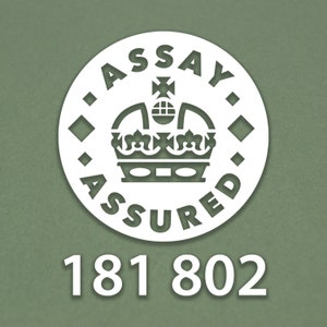 May include: White circle with the text "Assay Assured" and a crown inside. The number 181 802 is below the circle.