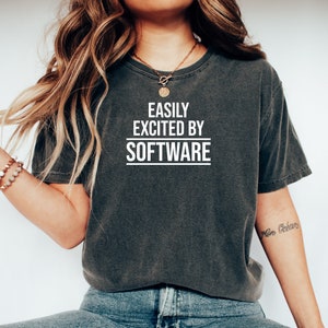 May include: A dark gray cropped t-shirt with the text "EASILY EXCITED BY SOFTWARE" printed in white on the front.