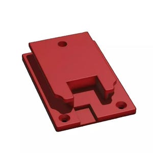 May include: A red plastic wall mount with a slot and four holes. The mount is designed to hold a device or object.