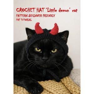 May include: A black crochet hat for a cat featuring two red devil horns on top. The text CROCHET HAT 'Little demon' cat PATTERN-BEGINNER FRIENDLY PDF TUTORIAL is printed in red above the cat wearing the black hat with tied chin straps.