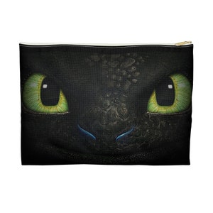 May include: Close-up of a black dragon's face with green eyes and a blue snout. The dragon's scales are visible.