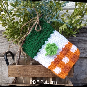 May include: Crochet Irish flag stocking with a green shamrock, white and orange stripes, and a brown twine bow.  PDF Pattern.