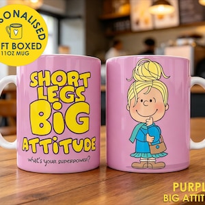 May include: A light purple ceramic mug featuring a cartoon character with blonde hair in a bun, wearing a blue sweater and scarf. The text reads SHORT LEGS BIG ATTITUDE and what's your superpower? The mug has a white handle and a 312ml capacity.