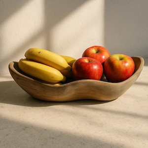 May include: A wooden bowl with a wavy edge holds a group of yellow bananas and red apples. The bowl is made of natural wood and has a rustic look.