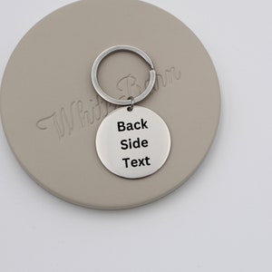 May include: Silver keychain with a round tag that says "Back Side Text".