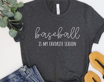 May include: A dark gray t-shirt with the text "baseball is my favorite season" in white lettering.