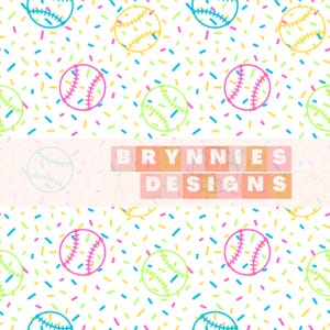 May include: A repeating pattern of baseballs in pink, yellow, and green, with white stitching, scattered across a white background. The background is filled with colorful sprinkles in blue, yellow, pink, and green. The text "BRYNNIES DESIGNS" is in the center.