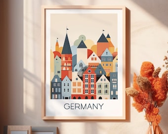 May include: A framed art print depicting a vibrant illustration of a cityscape with buildings in red, blue, orange, and yellow. The word "GERMANY" is printed in a bold font at the bottom of the print.