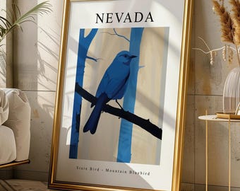 May include: A framed wall art print featuring a blue mountain bluebird perched on a dark branch against a light yellow and blue forest background. The text NEVADA is printed at the top, and State Bird - Mountain Bluebird is printed at the bottom.