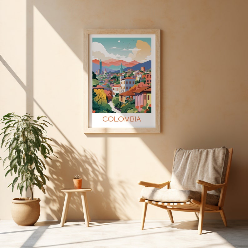 May include: A framed art print featuring a colorful illustration of a Colombian cityscape. The artwork showcases buildings, mountains, and trees in a vibrant palette. The word "COLOMBIA" is printed in orange at the bottom of the frame. The print is displayed on a beige wall.