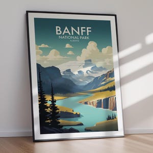 May include: Framed art print featuring a scenic view of Banff National Park in Alberta. The artwork showcases a turquoise river winding through a valley, with mountains and clouds in the background. The text "BANFF NATIONAL PARK ALBERTA" is displayed at the top.