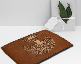 May include: Brown leather zippered pouch with a tree of life design and the name "MICHAEL" embossed in gold.