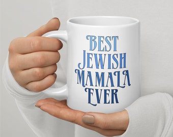 May include: White ceramic coffee mug with blue text that reads "Best Jewish Mama Ever".