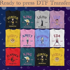 May include: A collection of colorful t-shirts featuring various characters and text from "The Owl House" series. Each shirt displays a character's name, the year 2020 or 2021, and "Boiling Isles". The shirts are in various colors.
