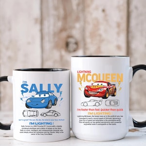 May include: Two white ceramic mugs with black handles. The mug on the left features a blue cartoon car with the text "I'm Sally, I'm Lighting!" The mug on the right features a red cartoon car with the text "Lightning McQueen, I'm faster than fast. Quicker than quick. I'm Lighting!"