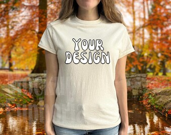 May include: A white t-shirt with the text "YOUR DESIGN" in a white, wavy font.