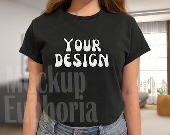May include: A black t-shirt with the text "YOUR DESIGN" in white, stylised lettering.