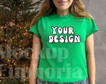May include: A green t-shirt with the text "YOUR DESIGN" in white bubble letters.