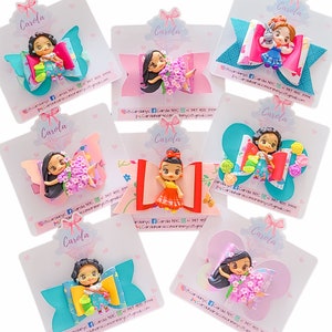 May include: A set of 8 colorful hair bows featuring different Disney princesses. Each bow is made with a variety of fabrics and embellishments, including glitter, sequins, and flowers. The bows are attached to a clip that can be used to secure them to hair.
