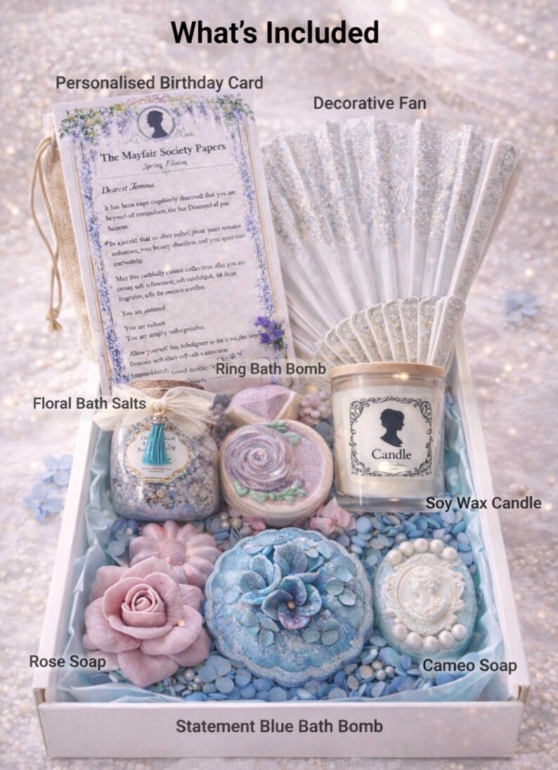 Luxury spa gift box contents including soy candle, bath salts, bath bombs, rose soap, cameo soap and decorative fan.