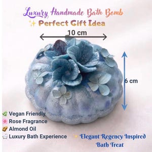 Large handmade blue floral bath bomb with hydrangea decoration showing size 10 cm by 6 cm, vegan friendly bath bomb with rose fragrance and almond oil.